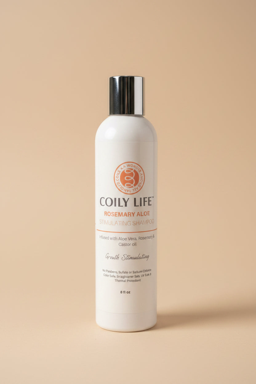 Coily Life shampoo bottle on a gray surface with a white background
