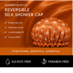 An orange promotional graphic for a reversible silk shower cap. The cap is shown on the right side, covered in small circular brand logos.